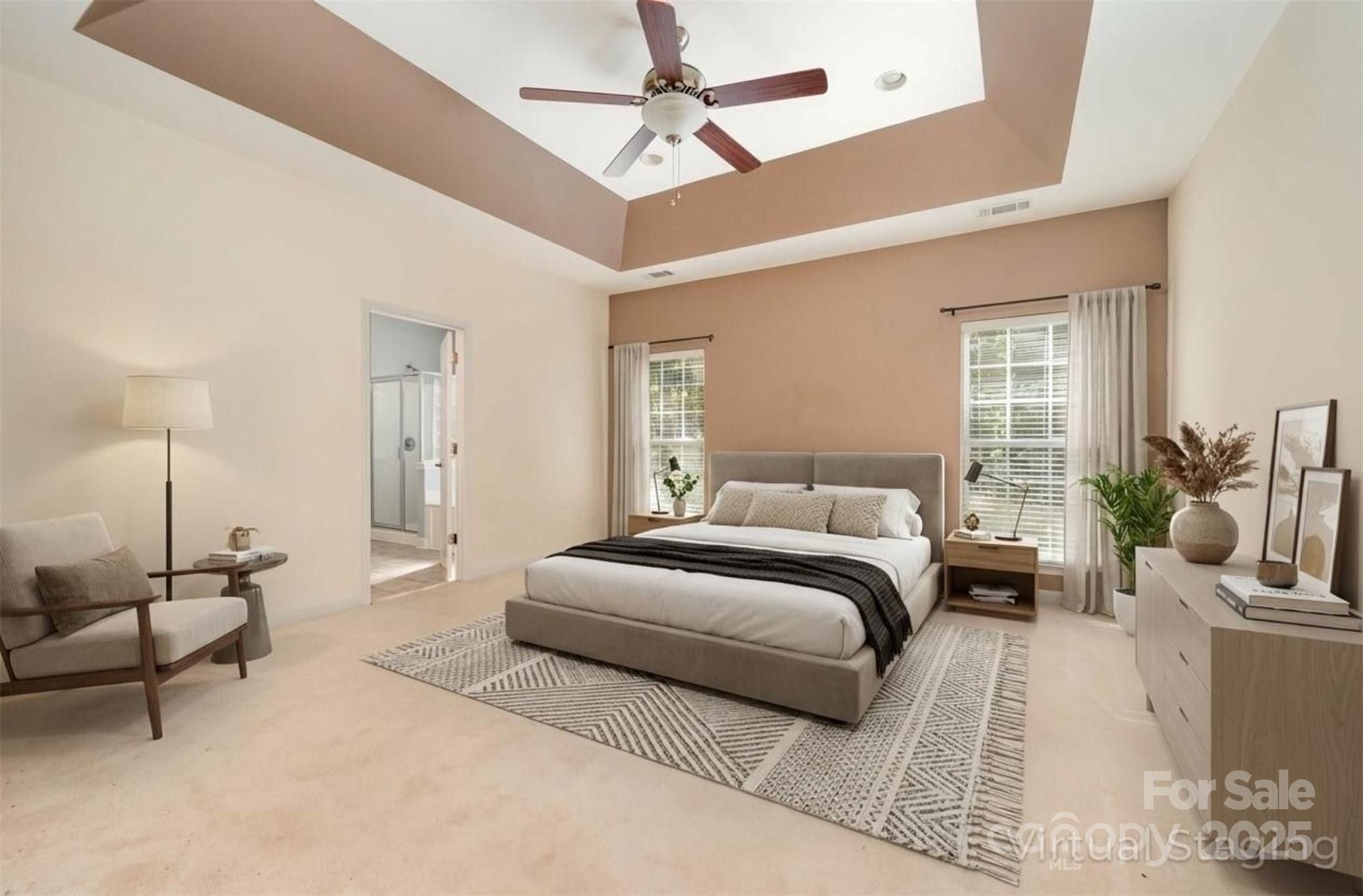 445 Buttermere Road Fort Mill, SC 29715 - Photo 12 of 42 a spacious bedroom with a bed a couch and a ceiling fan