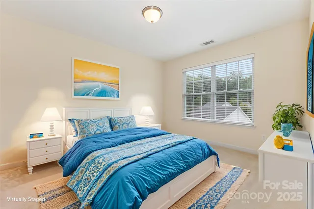 a bedroom with a bed and a potted plant