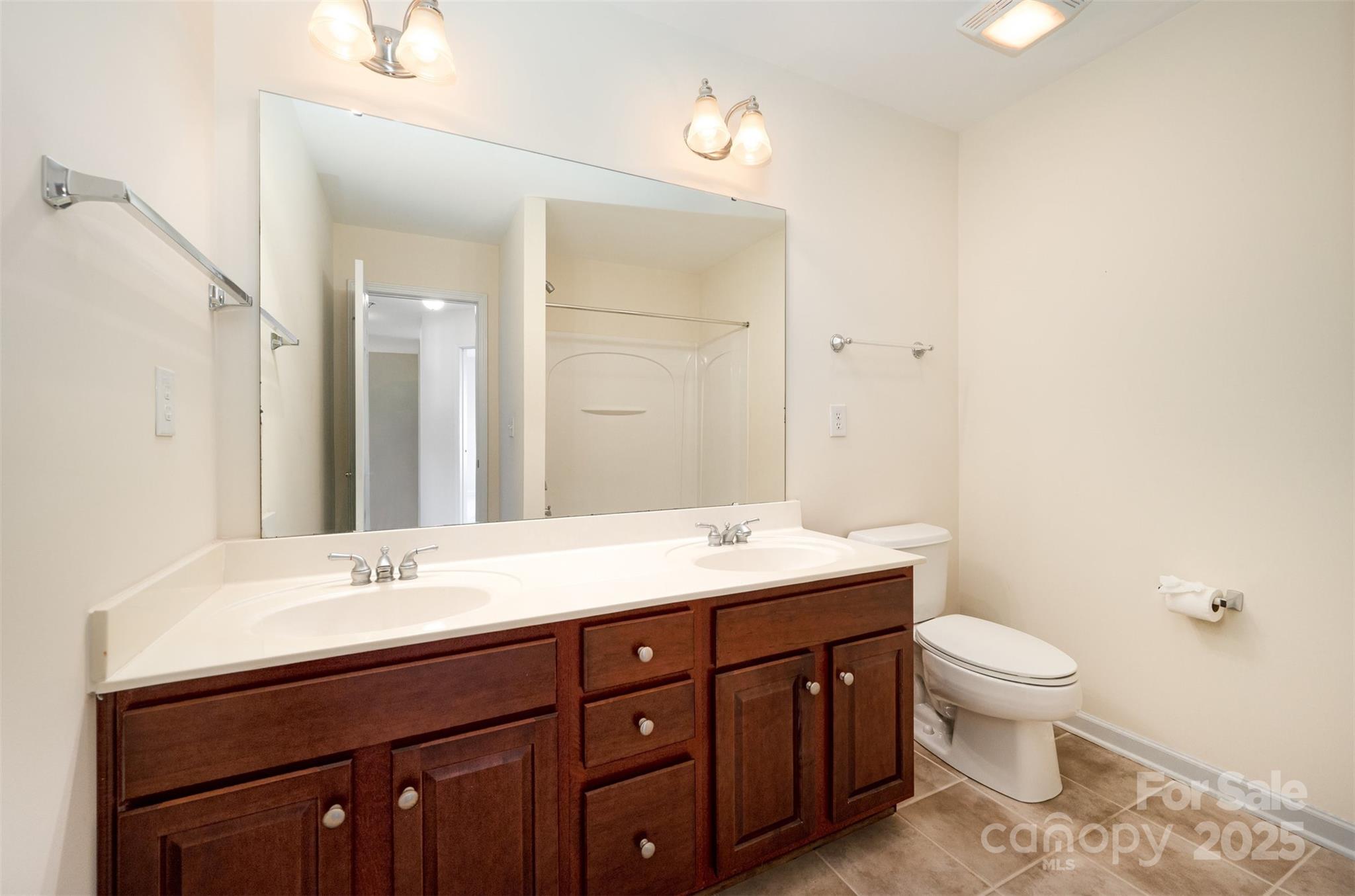 445 Buttermere Road Fort Mill, SC 29715 - Photo 20 of 35 a bathroom with a granite countertop sink a toilet and a mirror