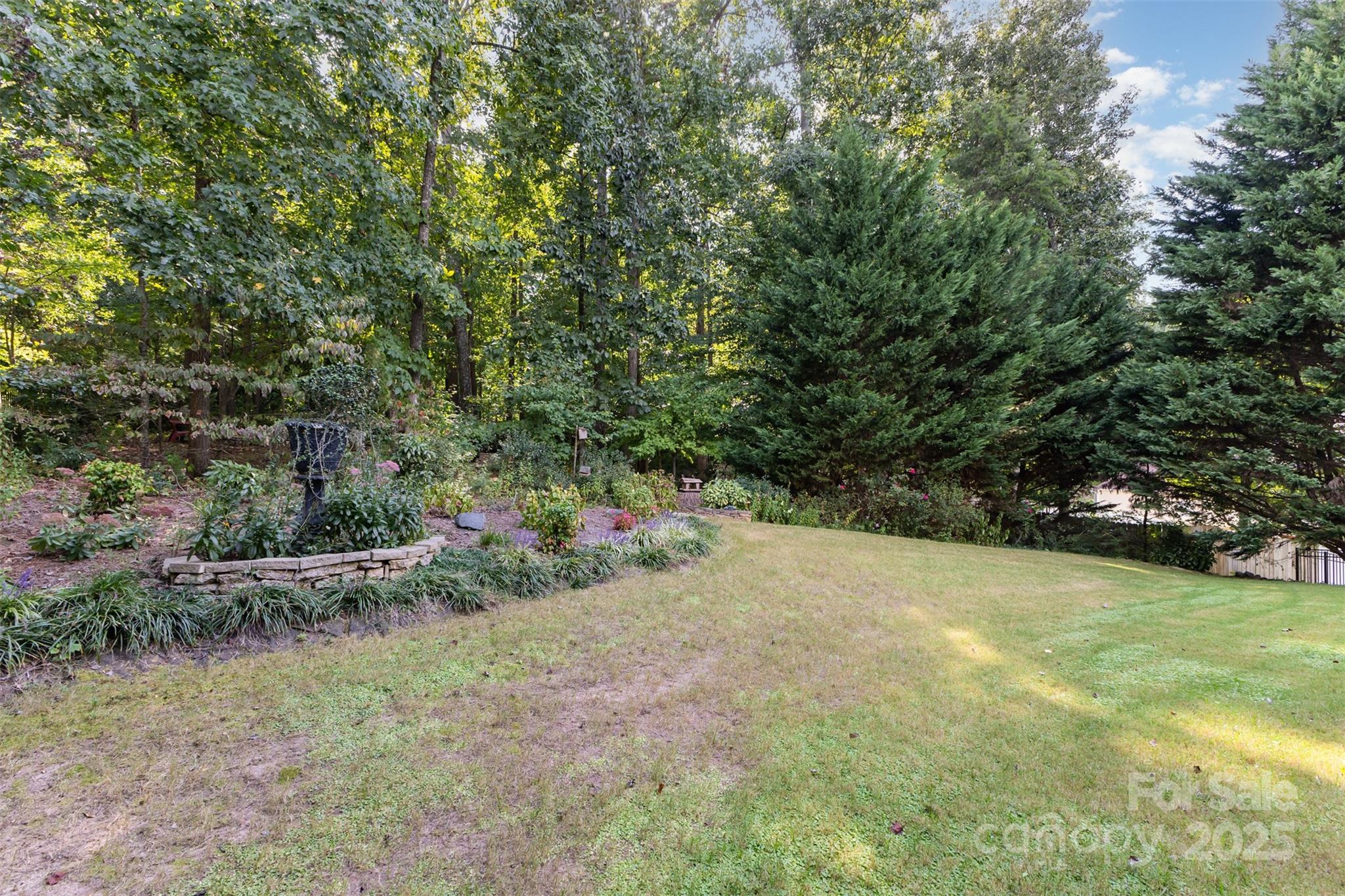 445 Buttermere Road Fort Mill, SC 29715 - Photo 27 of 35 a view of a field with plants and trees in the background