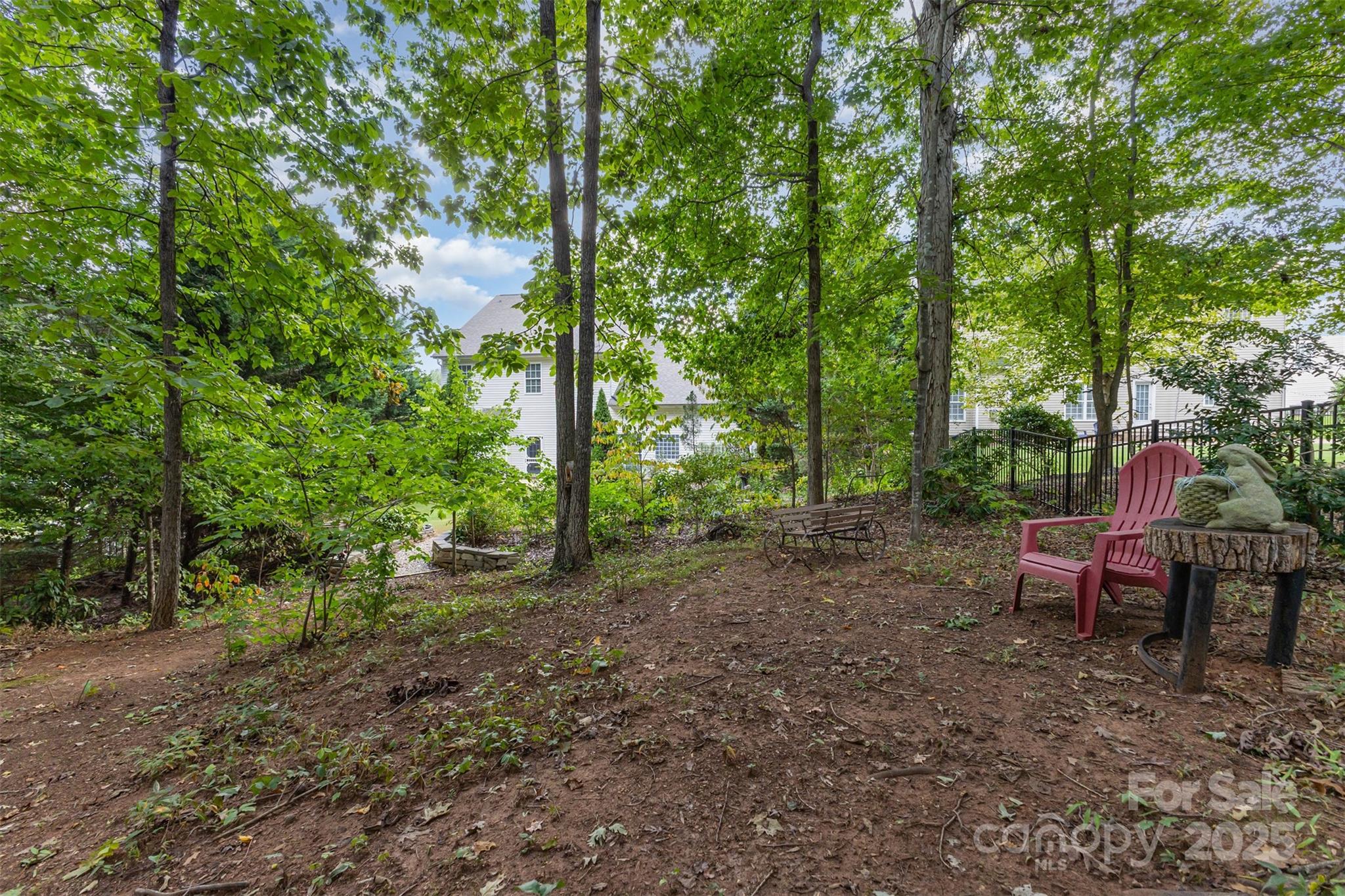 445 Buttermere Road Fort Mill, SC 29715 - Photo 37 of 42 a view of a wooden bench sitting in the middle of a forest