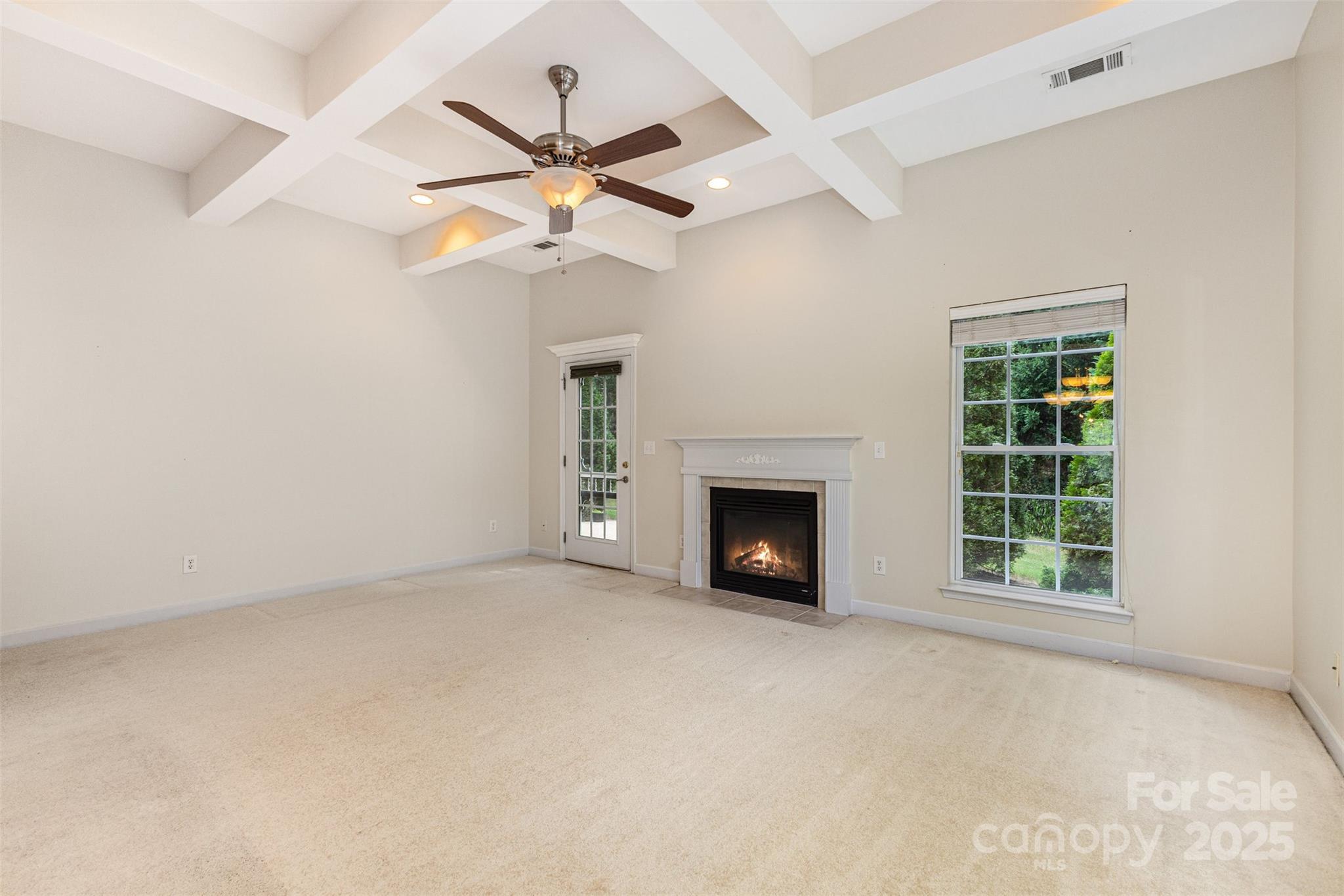 445 Buttermere Road Fort Mill, SC 29715 - Photo 4 of 42 an empty room with windows and fireplace