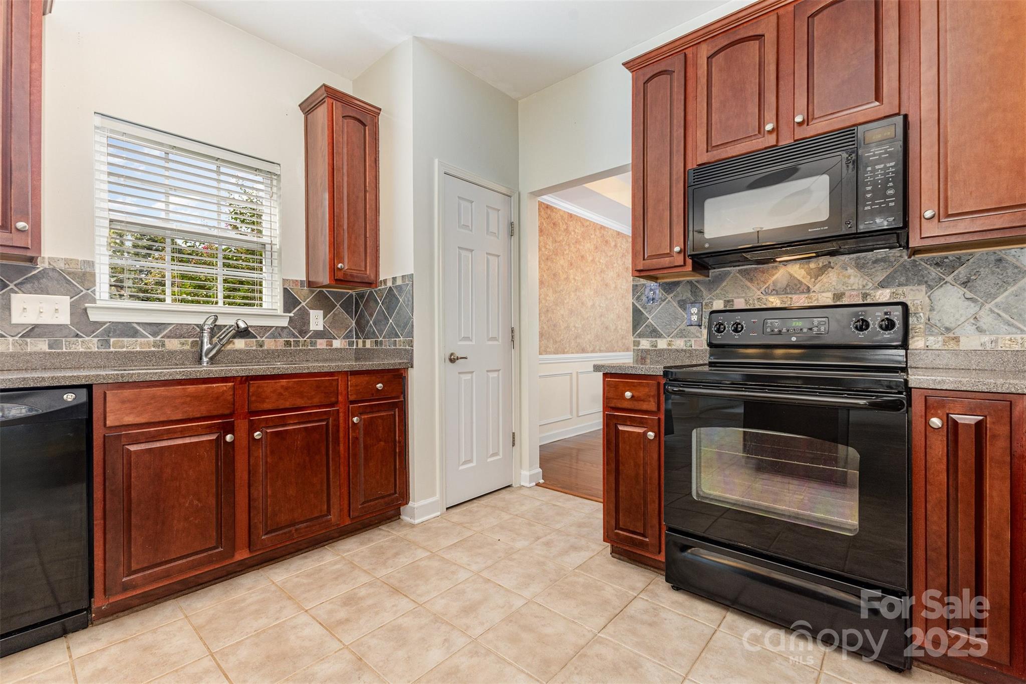 445 Buttermere Road Fort Mill, SC 29715 - Photo 6 of 35 a kitchen with stainless steel appliances granite countertop a stove microwave and sink