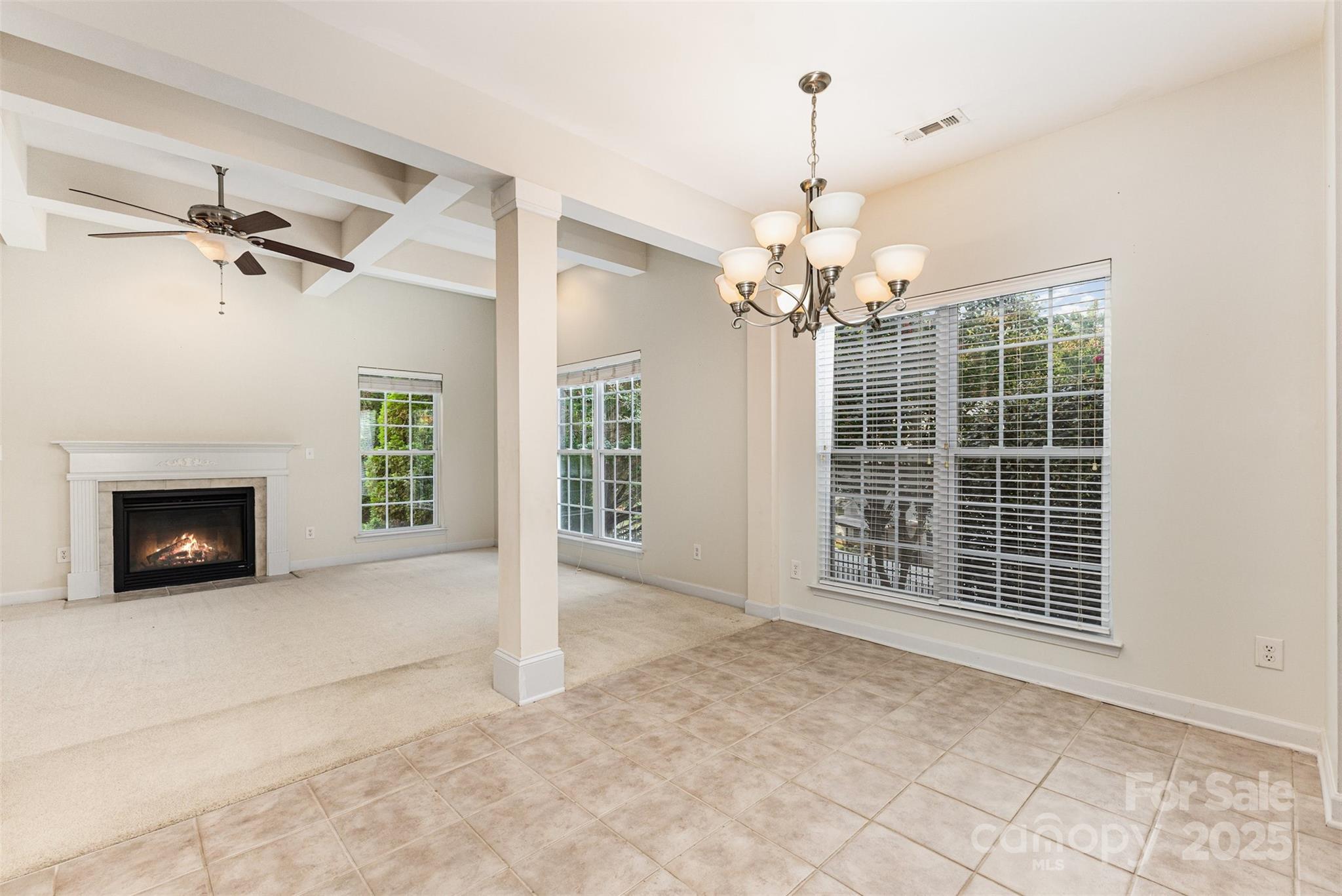 445 Buttermere Road Fort Mill, SC 29715 - Photo 6 of 42 a view of an empty room with a fireplace and a ceiling fan