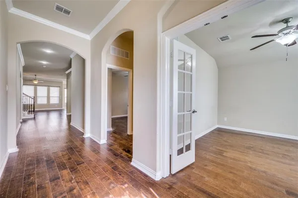 a view of a hallway with wooden floor