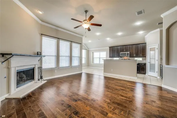 a view of a kitchen with a stove wooden cabinet and a fireplace