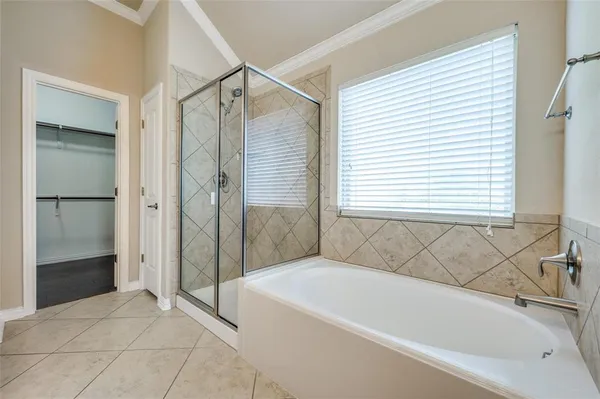 a bathroom with a bathtub and a shower