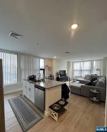 a kitchen with a sink a stove a counter space and a window