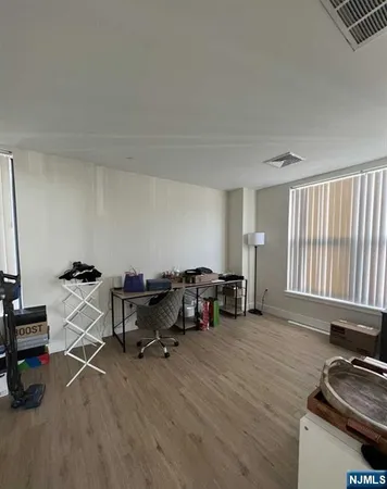 a view of a workspace with furniture and a window