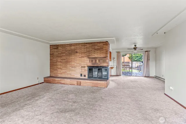an empty room with fireplace and windows