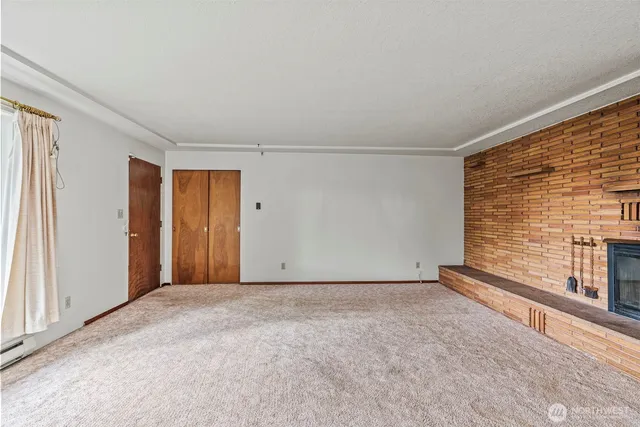 a view of an empty room with a fireplace