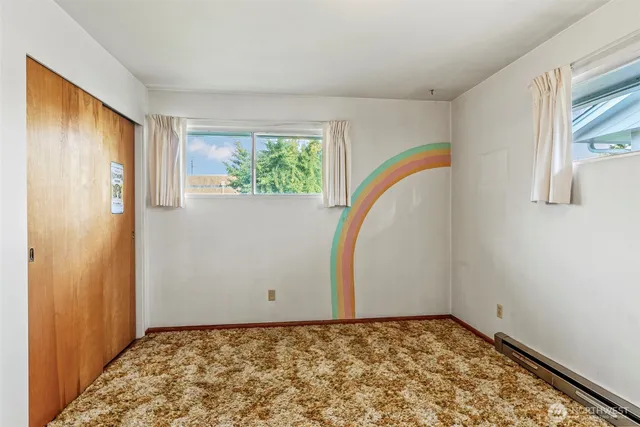 a view of a room with window and wooden floor