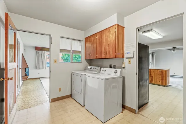 a view of kitchen with stainless steel appliances granite countertop a stove and a refrigerator