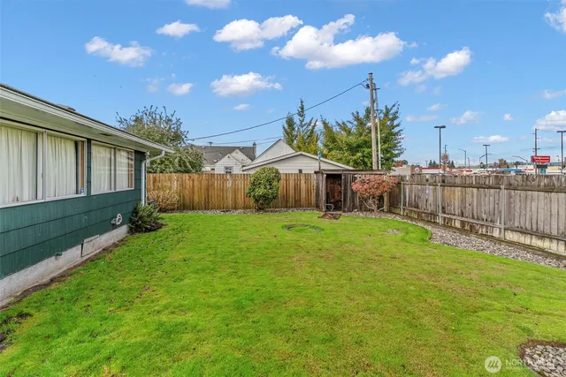 a view of a house with backyard and sitting area