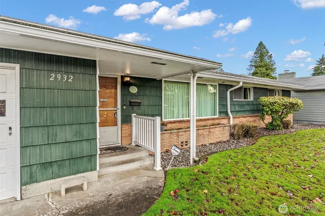 a view of a house with a garden and pathway