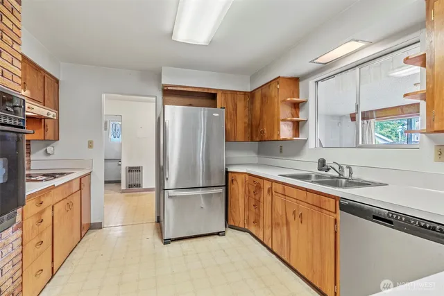 a kitchen with stainless steel appliances granite countertop a refrigerator a sink a stove a microwave and island