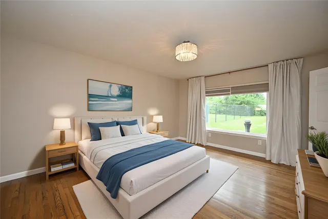 a bedroom with a large bed and a large window