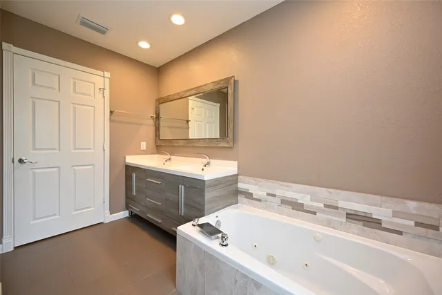 a bathroom with a tub and shower