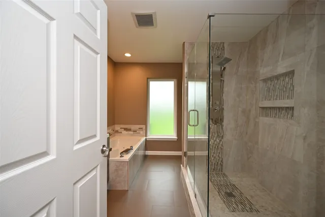 a bathroom with a tub and shower
