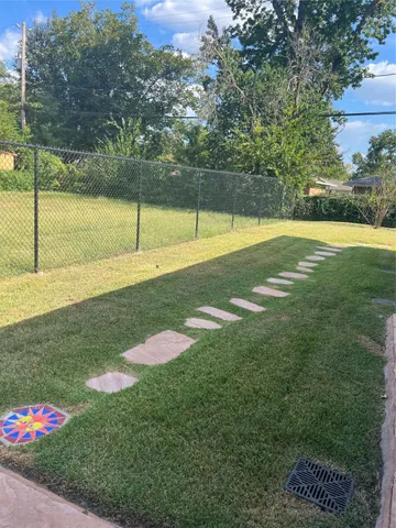 a view of a swimming pool with a yard