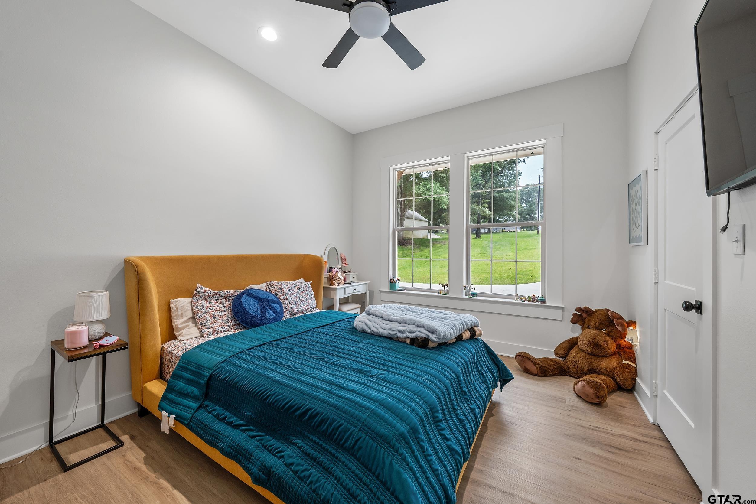 16837 Wilson Road Tyler, TX 75707 - Photo 29 of 44 a bedroom with a bed and a chandelier