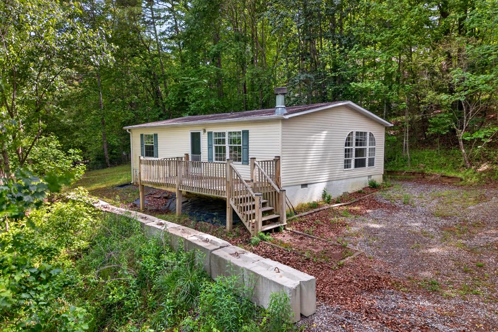 282 West Cherry Road Hayesville, NC 28904 - Photo 1 of 45 a view of a house with a yard and sitting area