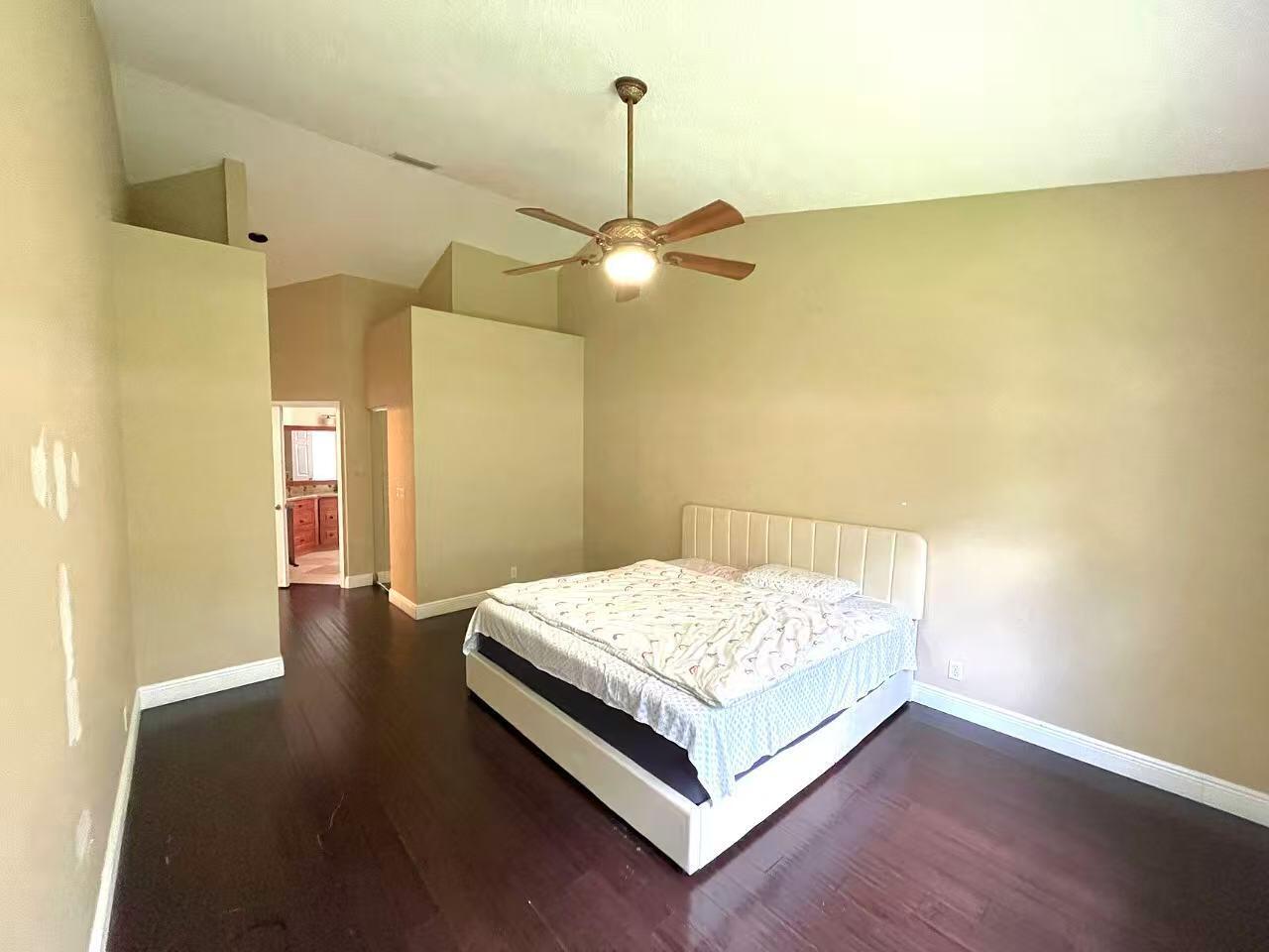 8550 Vía Romana, Unit 2 Boca Raton, FL 33496 - Photo 13 of 28 a bedroom with a bed and a chandelier