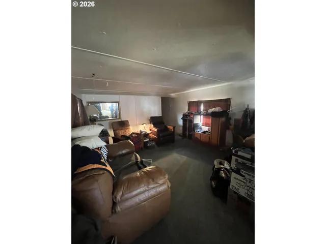 a living room with furniture and a gym cycle