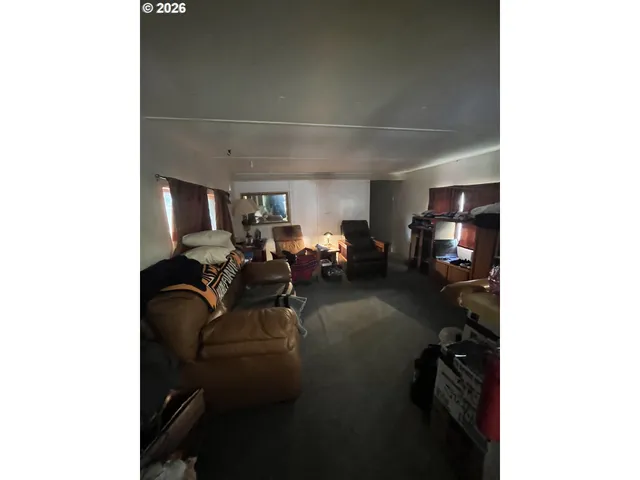 a living room with furniture a window and gym cycle