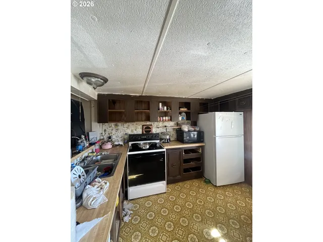 a kitchen with refrigerator and window
