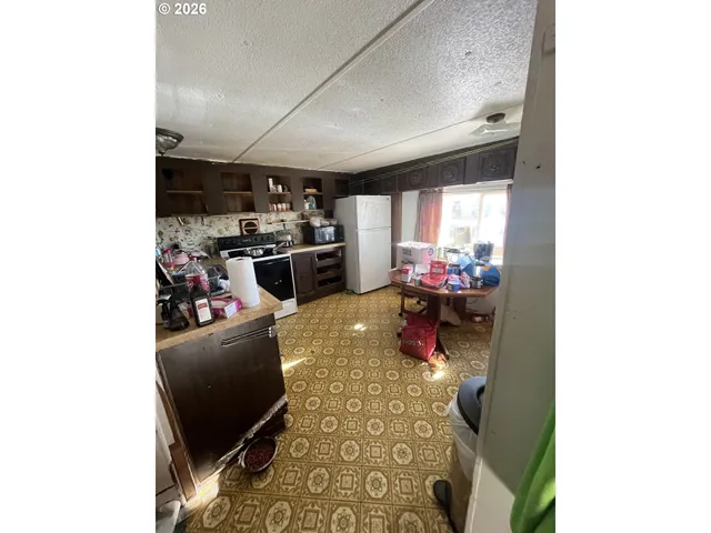 a kitchen with a stove and a refrigerator