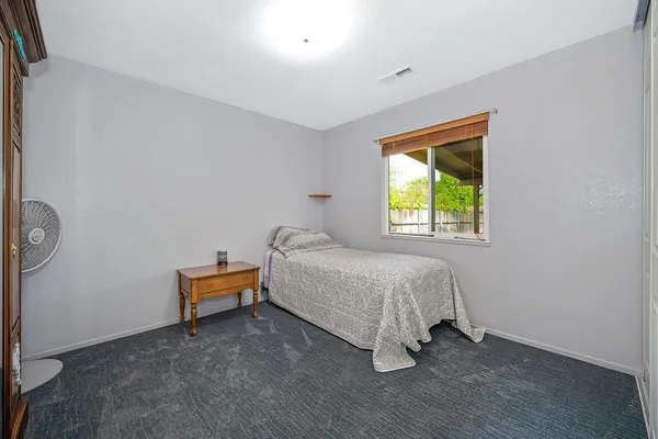 a bed room with a bed and a window