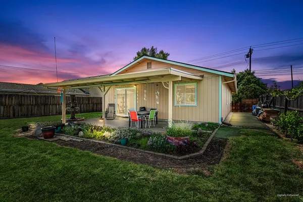 a front view of a house with patio and garden