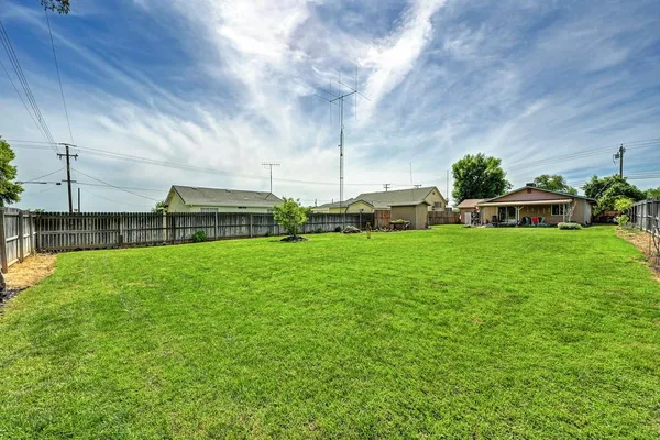 a backyard of a house with table and chairs
