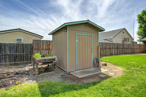 a front view of a house with a garden and yard