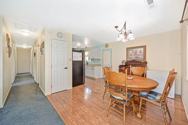 a view of a dining room with furniture and wooden floor