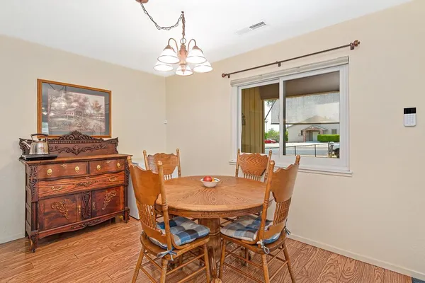 a dining room with furniture and window