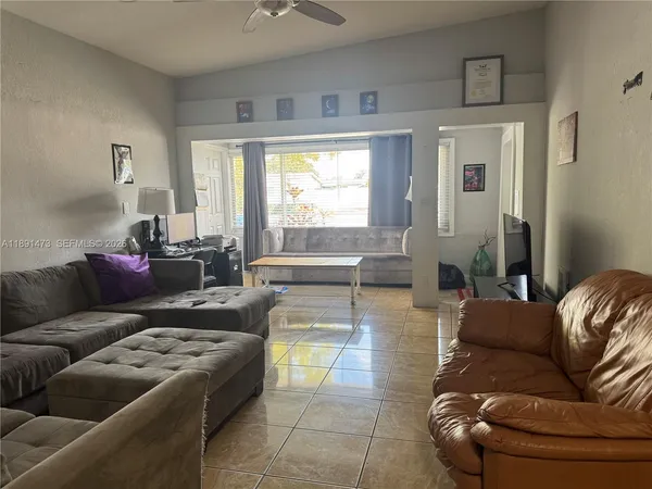 a living room with furniture and a large window