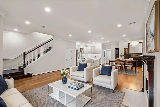 a view of house in front of a big yard with large trees
