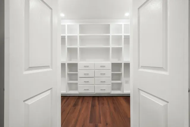 a view of a kitchen with wooden floor and a sink