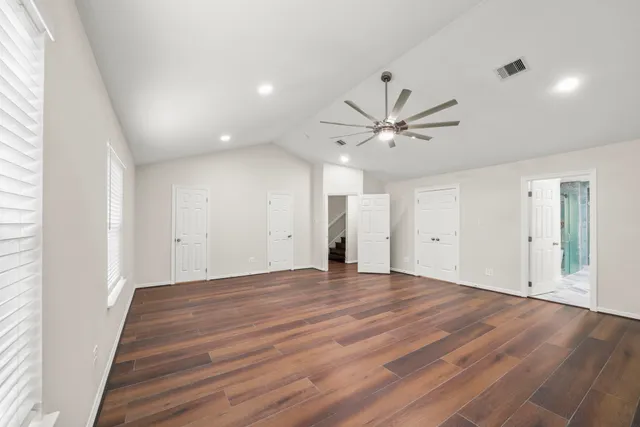 a view of a walk in closet with empty racks