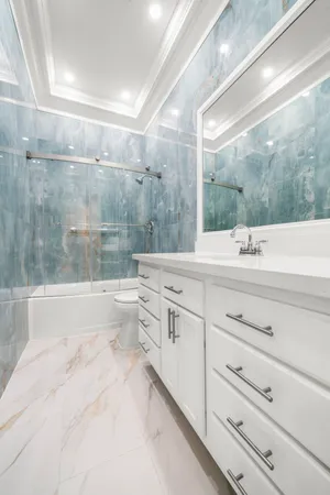 a bathroom with a shower and a sink