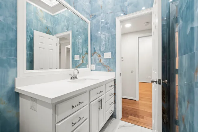 a bathroom with a sink mirror and a bathtub