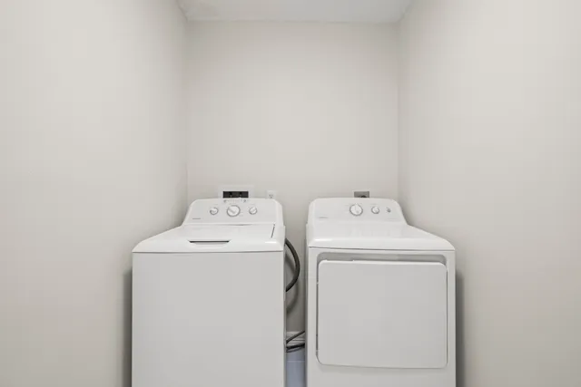 a view of an empty room with wooden floor and a ceiling fan