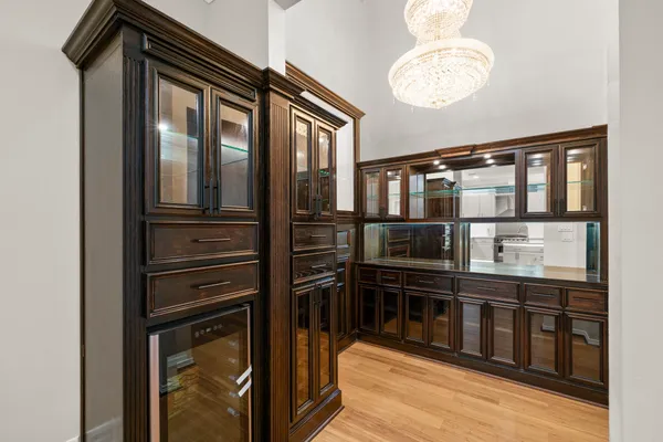 a kitchen with stainless steel appliances granite countertop a refrigerator a stove a sink and white cabinets with wooden floor