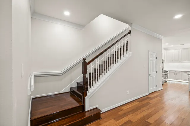 a view of a hallway with wooden floor