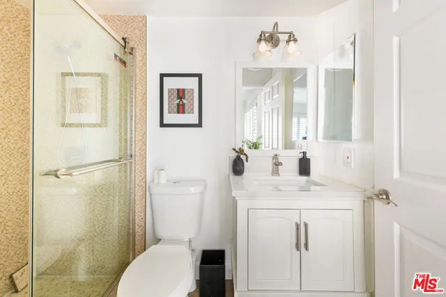 a bathroom with a sink toilet and shower