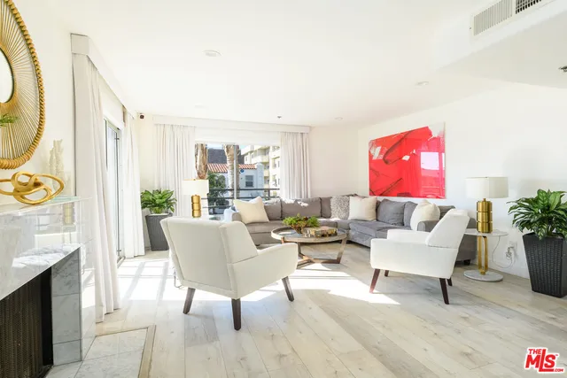 a living room with furniture a rug and a painting on the wall