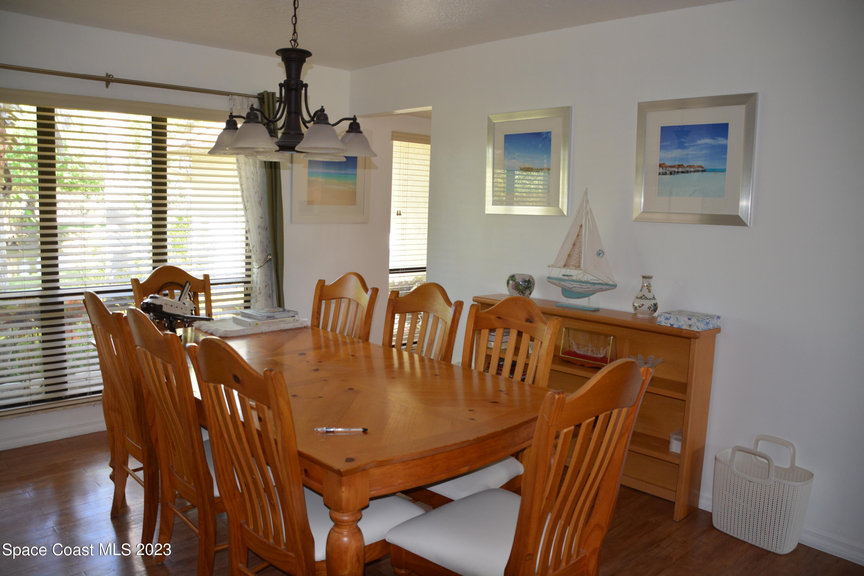 1045 Pine Island Road Merritt Island, FL 32953 - Photo 6 of 42 a view of a dining room with furniture window and wooden floor
