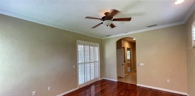 wooden floor in an empty room with a window